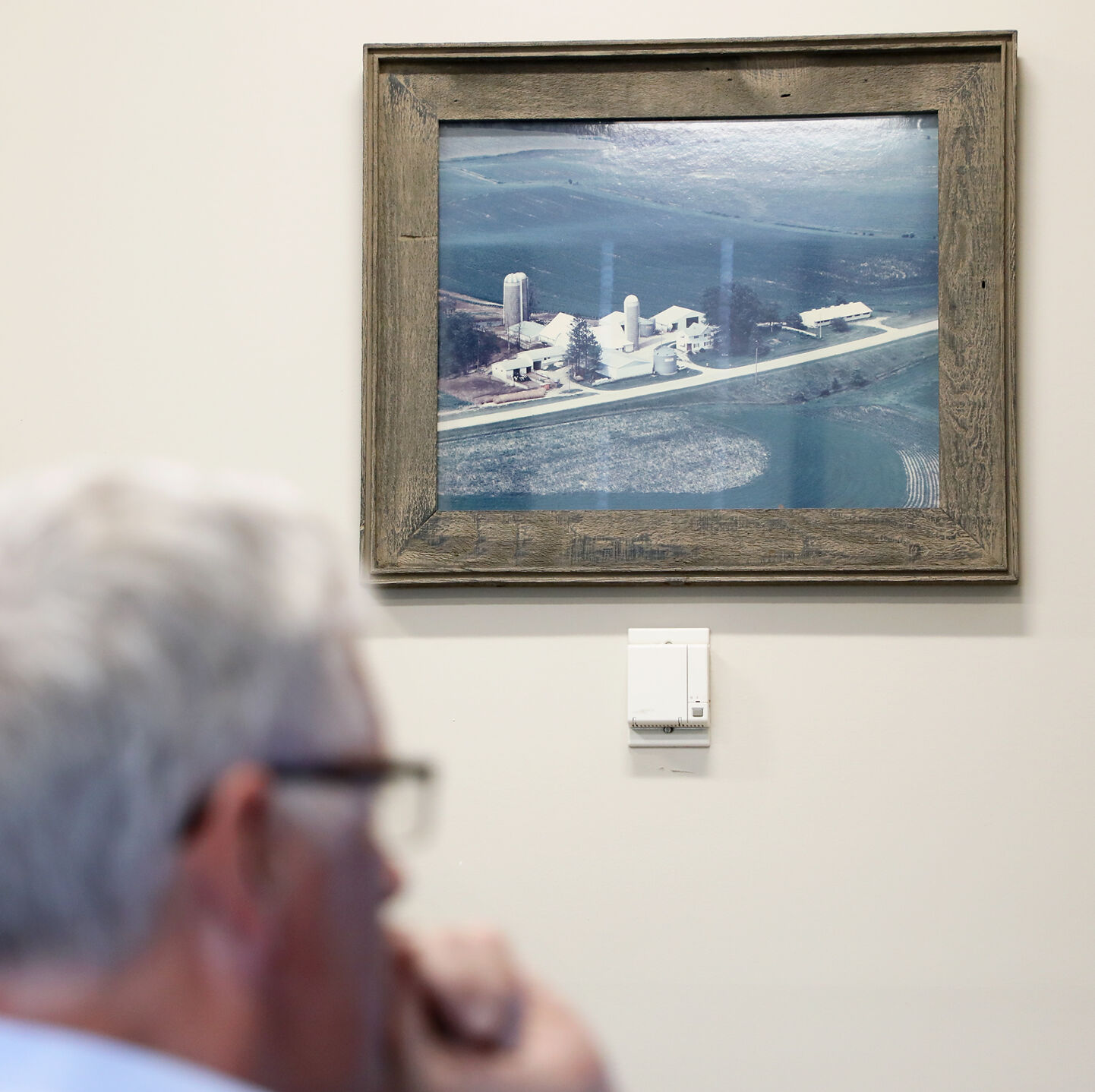 A photograph of Patrick Westhoff’s family’s former dairy farm hangs on the wall in his office